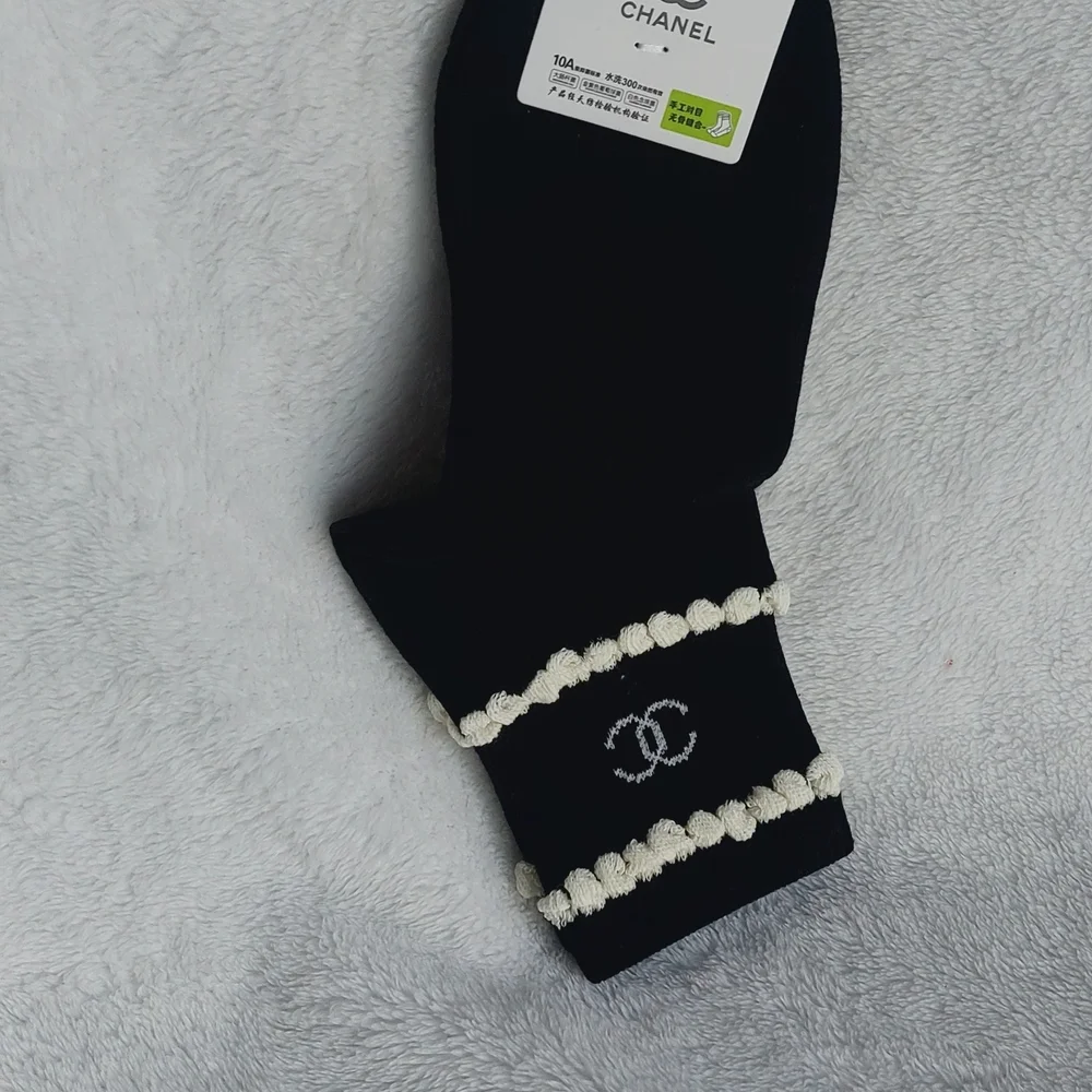 2 Pair of socks. 1 Cream trimmed in Black, 1 Black trimmed In Cream Women Size 7